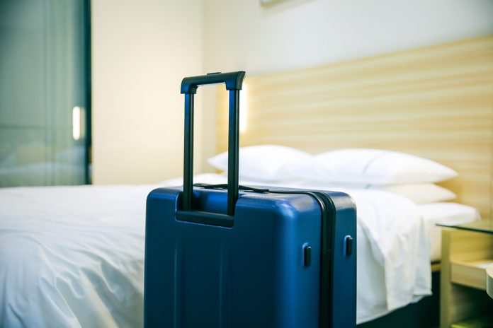 Suitcase In Hotel Room