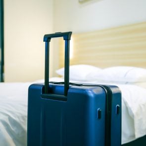 Suitcase In Hotel Room