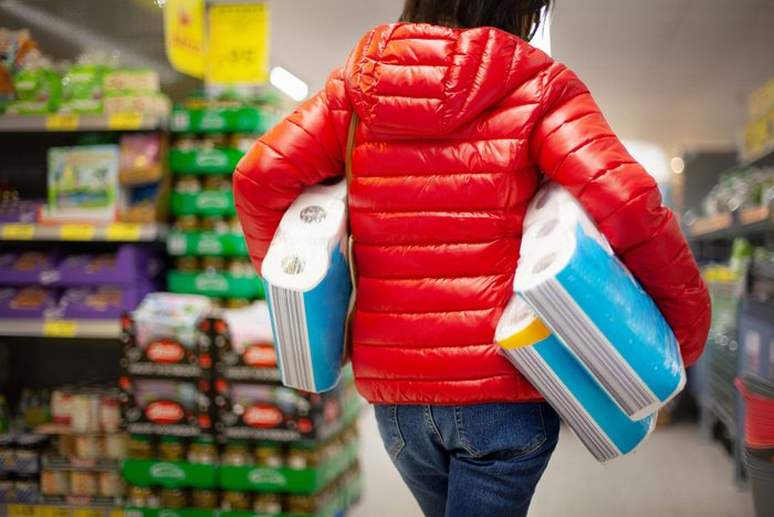Woman at the supermarket, buying paper towels in abundance for lack of toilet paper