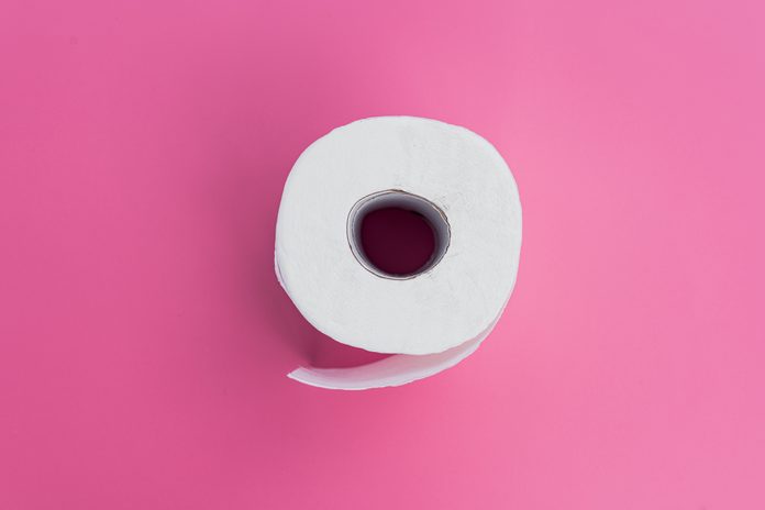 White toilet paper on pink background