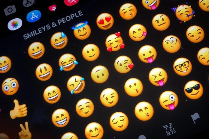 close up of emojis keyboard on an ipad or iphone in dark mode