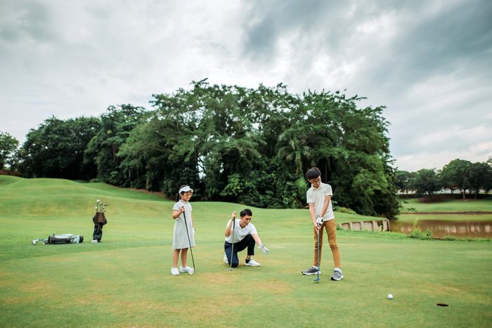 father golfing with son and daughter on father's day