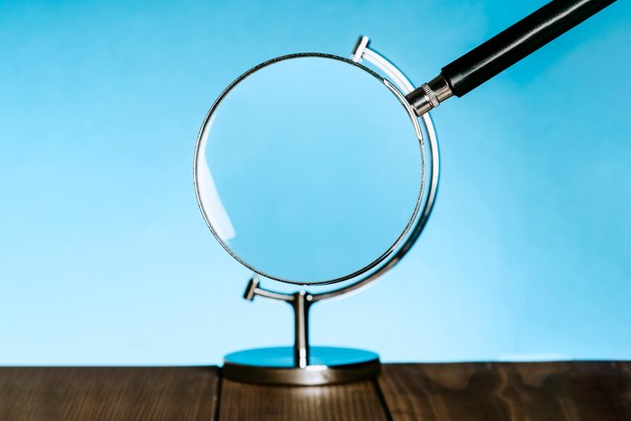 magnifying glass becomes the globe on a stand that usually holds a model of the earth