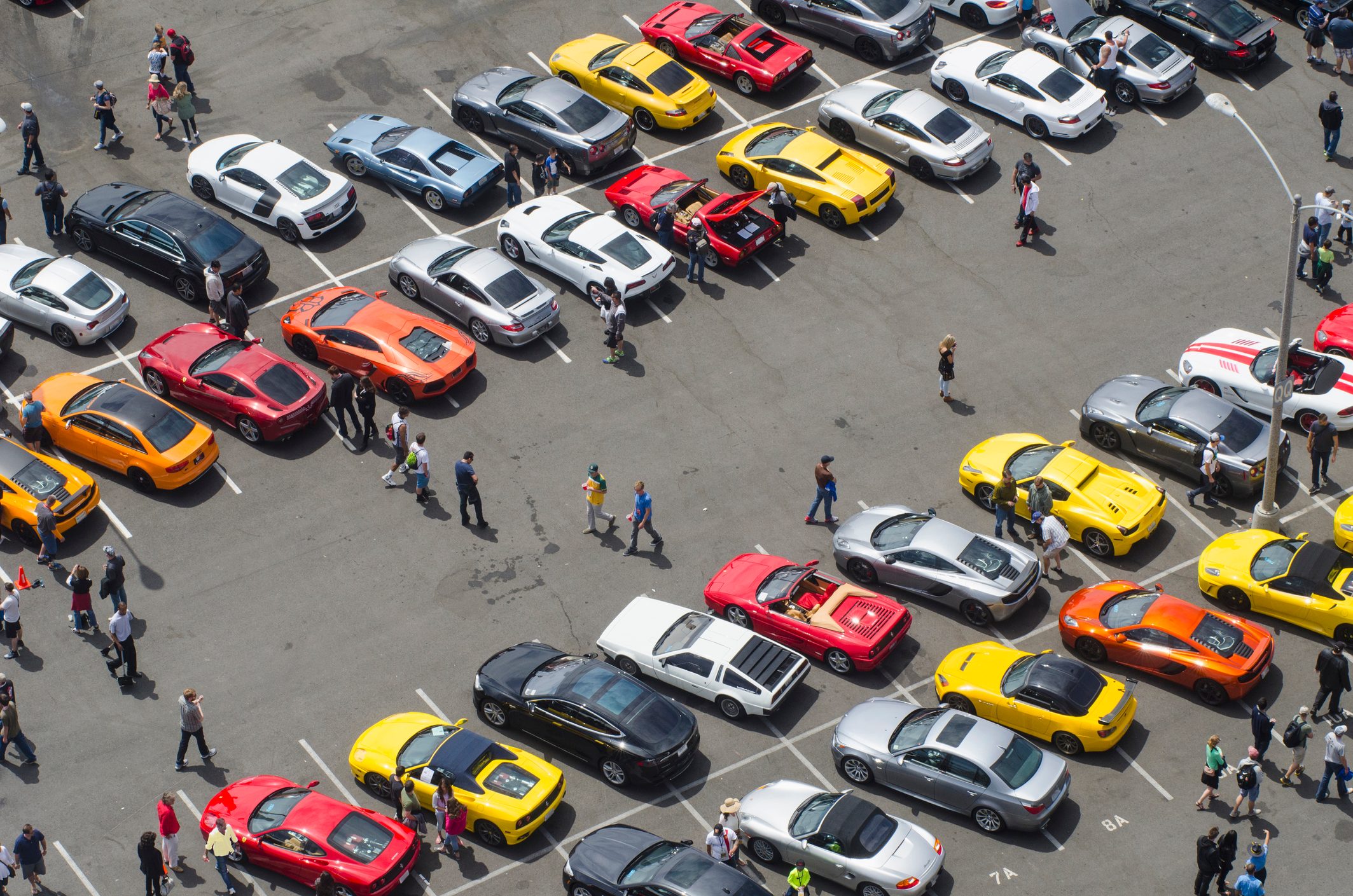 Father and children at a car show from above