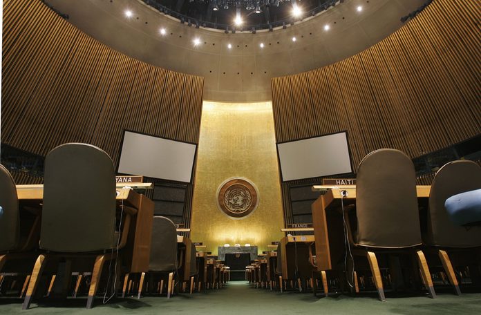 The United Nations logo on the back wall of the General Assembly Hall of the United Nations is seen from the floor May 12, 2006 at the United Nations headquarters in New York.