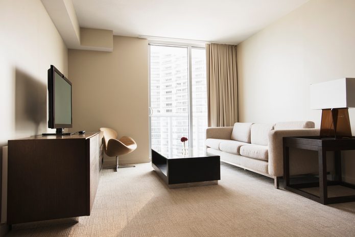 Sofa, coffee table and television in modern hotel room