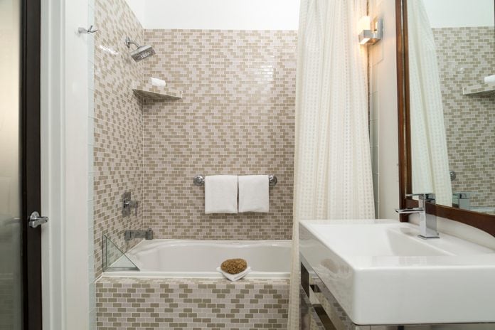 Tiled Bathroom with Shower and Vanity in a Hotel