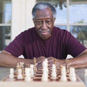 Senior African man playing chess