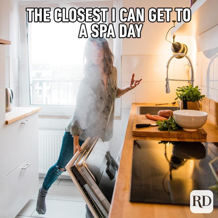 Woman being covered with steam from the dishwasher. MEME TEXT: The closest I can get to a spa day...