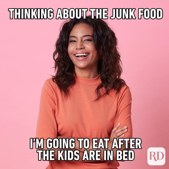 Woman with arms crossed, smiling. MEME TEXT: Thinking about the junk food I'm going to eat after the kids are in bed