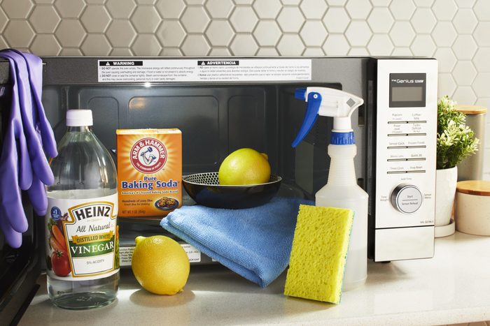 a microwave with cleaning products used to clean it