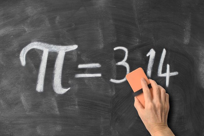 hand threatening to erase some of the digits of pi on a chalkboard