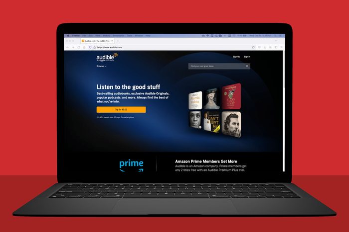 laptop screen showing audible.com, red background