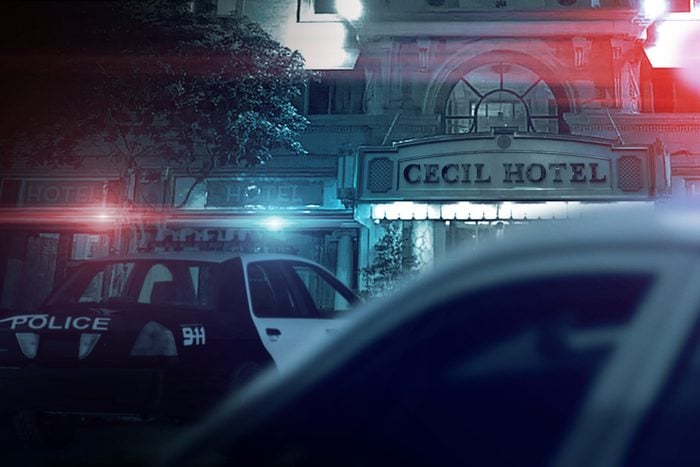 Police cars with lights flashing in front of Cecil Hotel