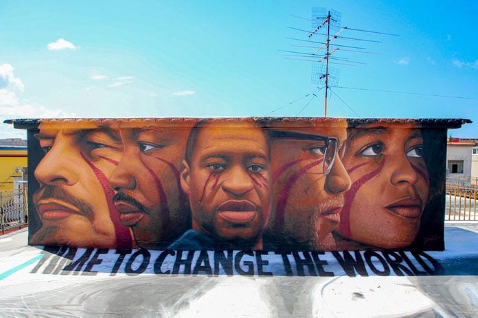 A mural painting on a roof made by street artist Jorit Agoch depicting George Floyd, Wladimir Ilic Ulianov Lenin, Malcolm X, Angela Davis, Martin Luther King and a write "Time to change the world".