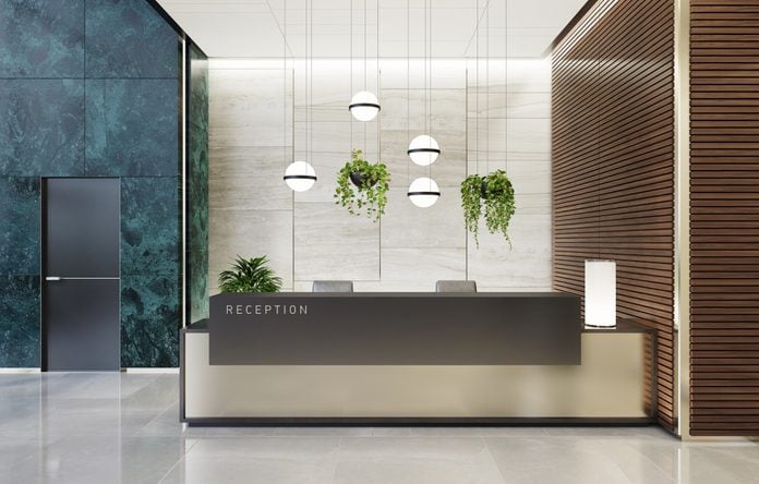 Modern Offices lobby interior area with elevators and stairs and with long reception desk