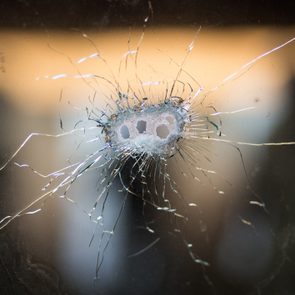 Bullet holes in cracked glass