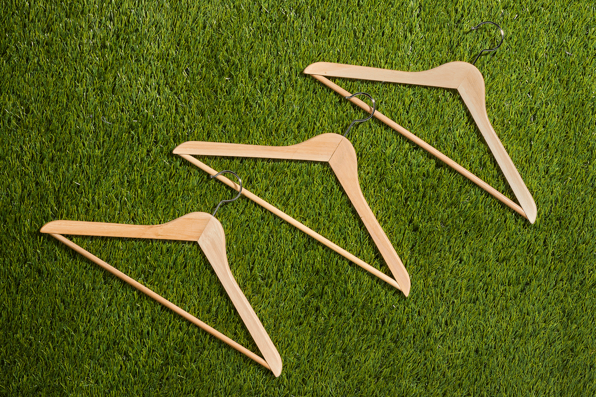 three hangers dancing on a grass surface