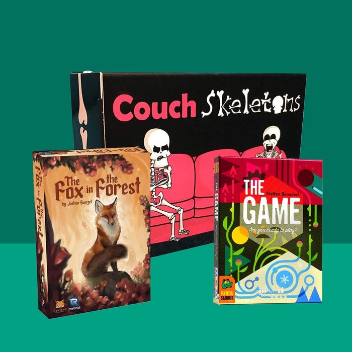 Three 2 player card game covers in front of green background