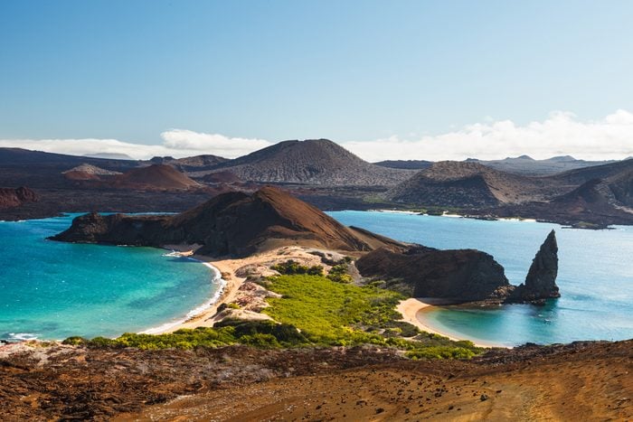 View on the volcanic landscape of Bartolome Island with famous Pinnacle Rock and Golden Beach in the Galápagos Islands, Ecuador