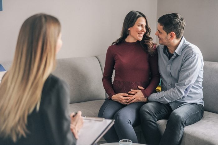 Genetic counseling consultant advising couple during pregnancy