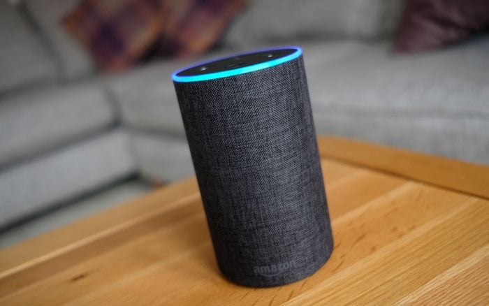 Amazon Echo device with Alexa on a coffee table in a living room