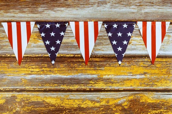 stars and stripes pennant banner on wood background