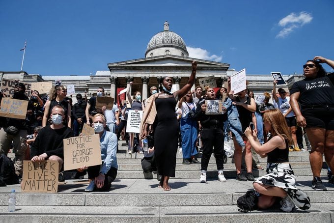 People with signs gather for a Black Lives Matter protest in London, England