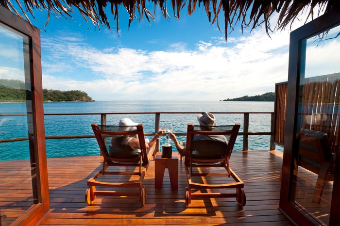 Couple relaxing in an over water bungalow