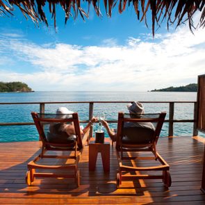 Couple relaxing in an over water bungalow