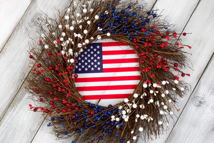 Independence Day wreath with flag on rustic white wooden boards