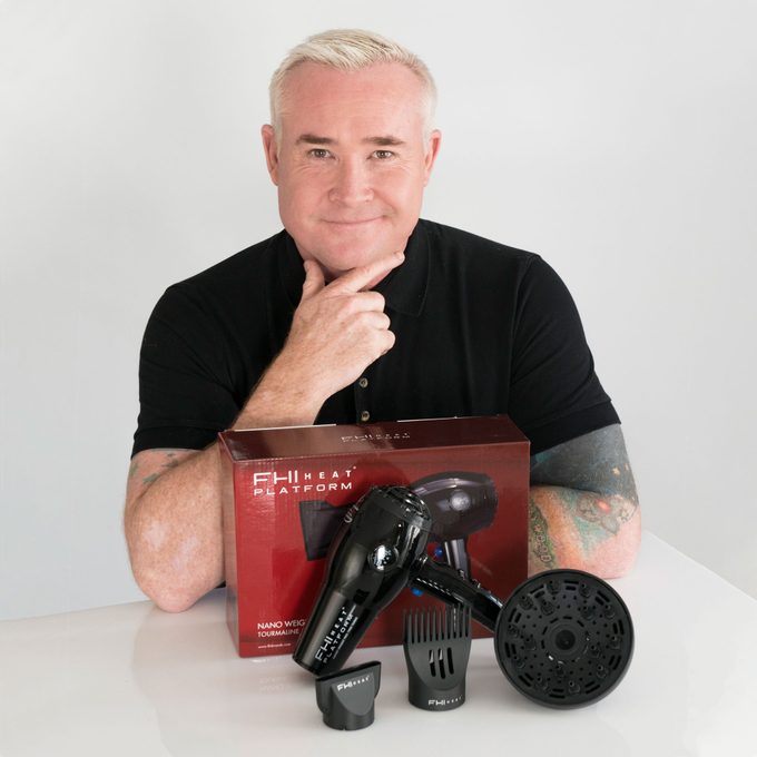 Sean James, Artistic Director of FHI Heat poses with FHI Heat Platform Nano Salon Pro 2000 hairdryer