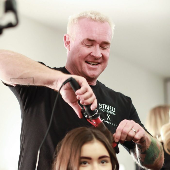 FHI Heat's Artistic Director Sean James syles a model's hair at an event