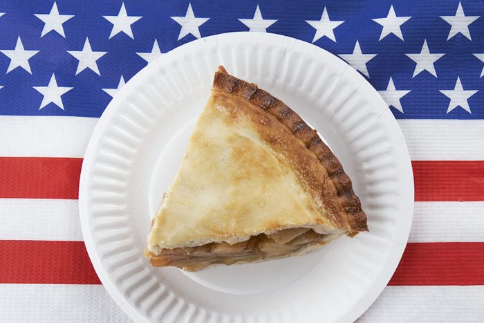 slice of apple pie on a plate on american flag napkin