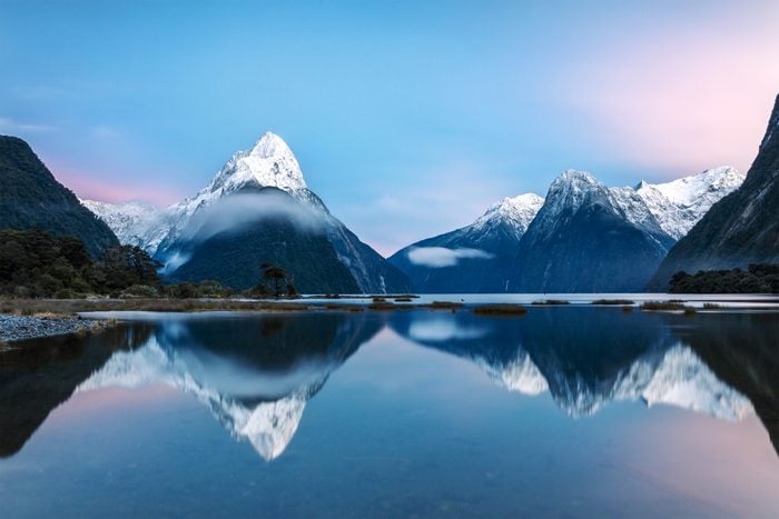 sunrise over Mitre peak and mountains of Milford Sound, Fiordland National Park, Southland, New Zealand