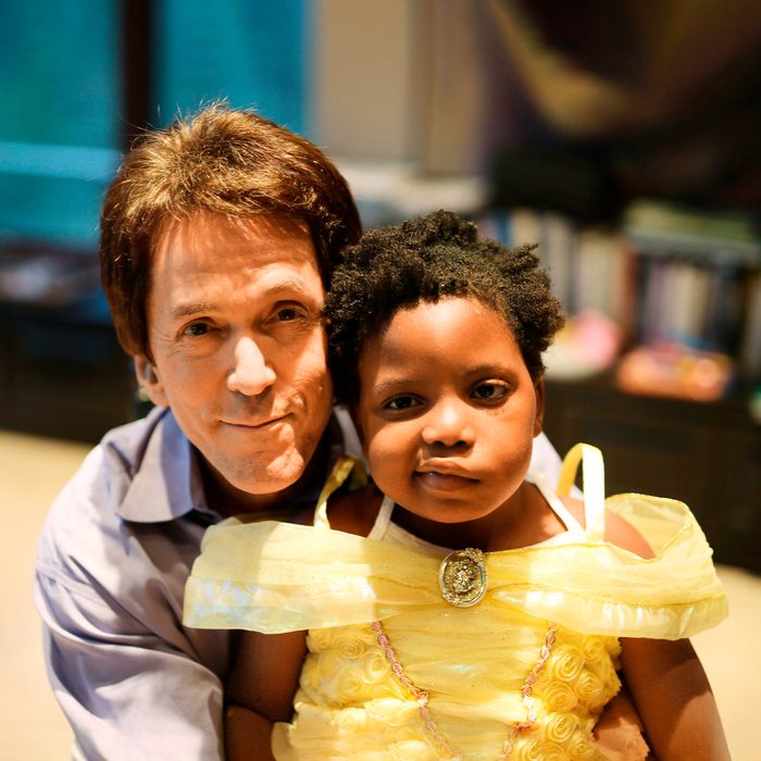 Mitch Albom hugging Chika an orphaned girl from Haiti who developed a rare brain tumor