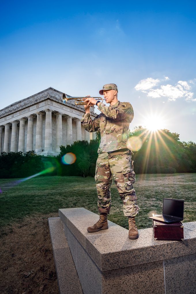 Sergeant Jacob Kohut playing trumpet in full army outfit