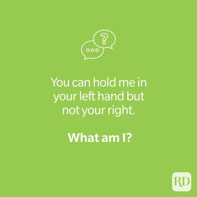 Hand riddle on green that reads "You can hold me in your left hand but not your right. What am I?"