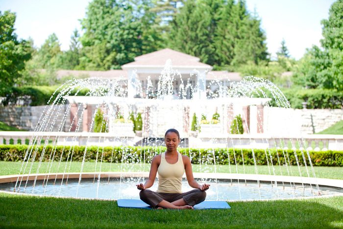 woman meditating in front of fountain at Canyon Ranch Lenox, massachusetts
