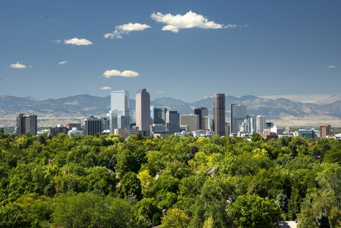 Denver, Colorado skyline with trees and mountains