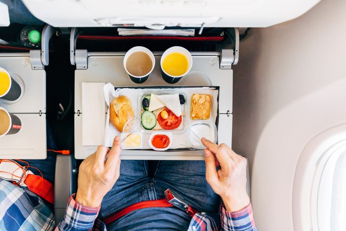 Eating airplane food during a flight, personal perspective directly above view