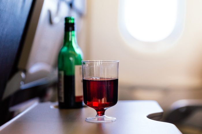 Plastic cup of red wine in the airplane