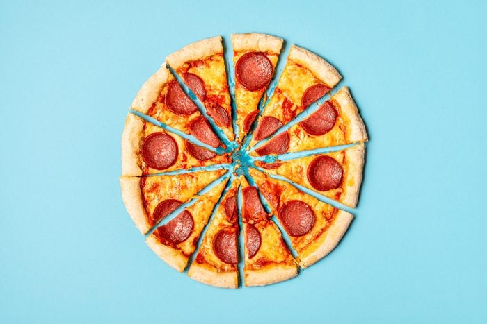 slices of pizza making a whole pizza on a blue background