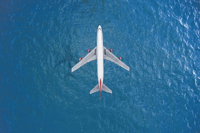 Passenger plane Fly over blue sea.