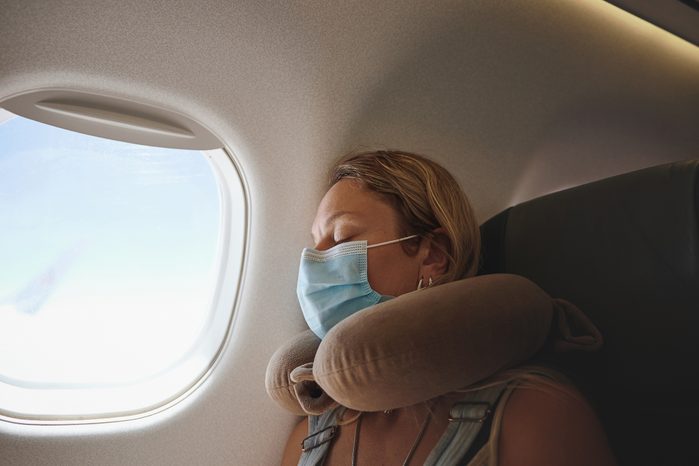 Shot of a young woman sleeping in the aeroplane