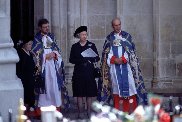 Queen Elizabeth II and Queen Mother at Funeral of Diana, Princess of Wales - At Westminster Abbey awaiting the arrival of the coffin of Diana, Princess of Wales, dressed in black standing next to priests