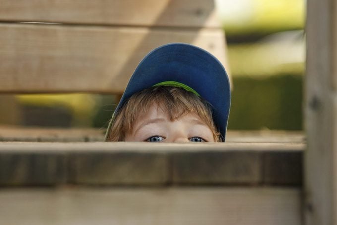 Little Boy Hiding At Playground