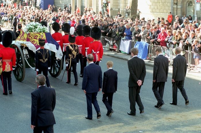 Onlookers line the street while the procession following Princess Diana's coffin walks through