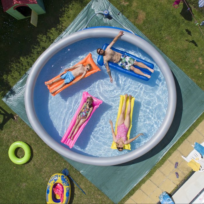 Family enjoying an inflatable pool in the summer time