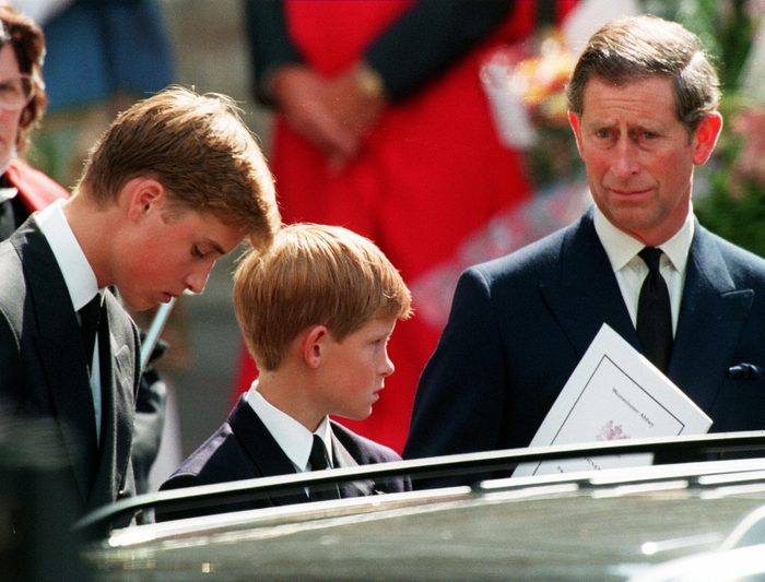 Former husband of Diana Prince Charles (L) and their two sons Harry (C) and William wait in front of the Westminster Abbey in London after the funeral ceremony of Princess of Wales